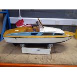 Wooden hand built model boat on stand