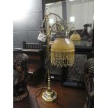 Brass table lamp with coloured glass shade