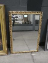 Rectangular bevelled mirror in decorative gilt frame