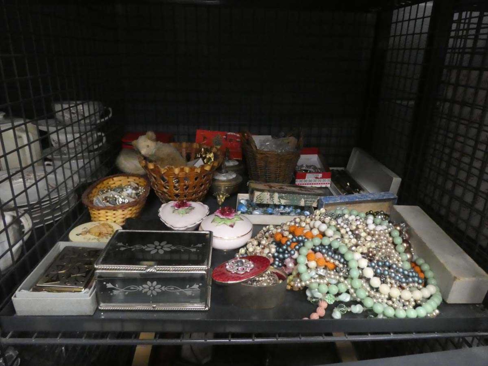 Cage containing costume jewellery, trinket boxes, and fountain pens