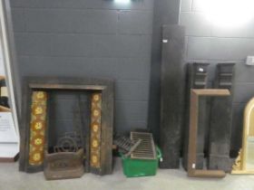 Two fire surrounds plus a quantity of cast iron baskets and grates