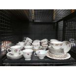 Cage containing quantity of rose patterned crockery