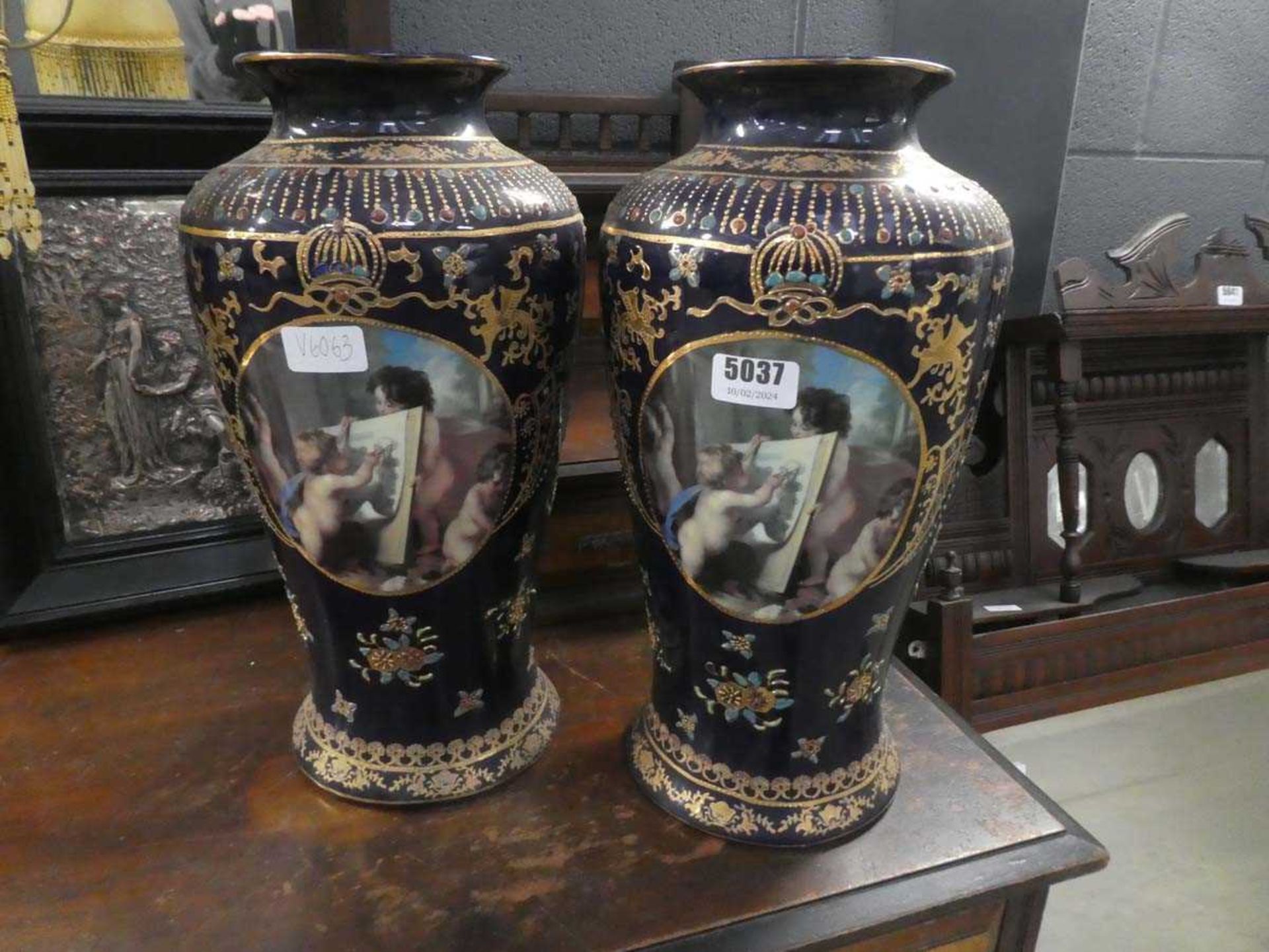 Pair of navy blue and gilt glazed vases with classical scenes