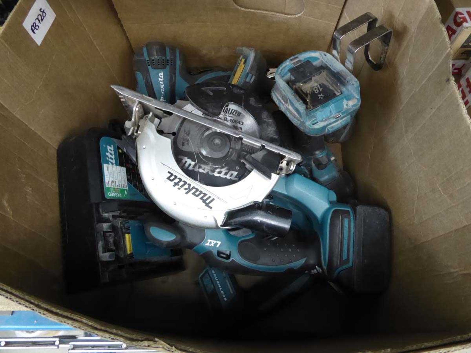 Box of Makita tools including circular saw, impact drive, reciprocating saw, 2 batteries and