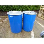 2 blue barrels with lids