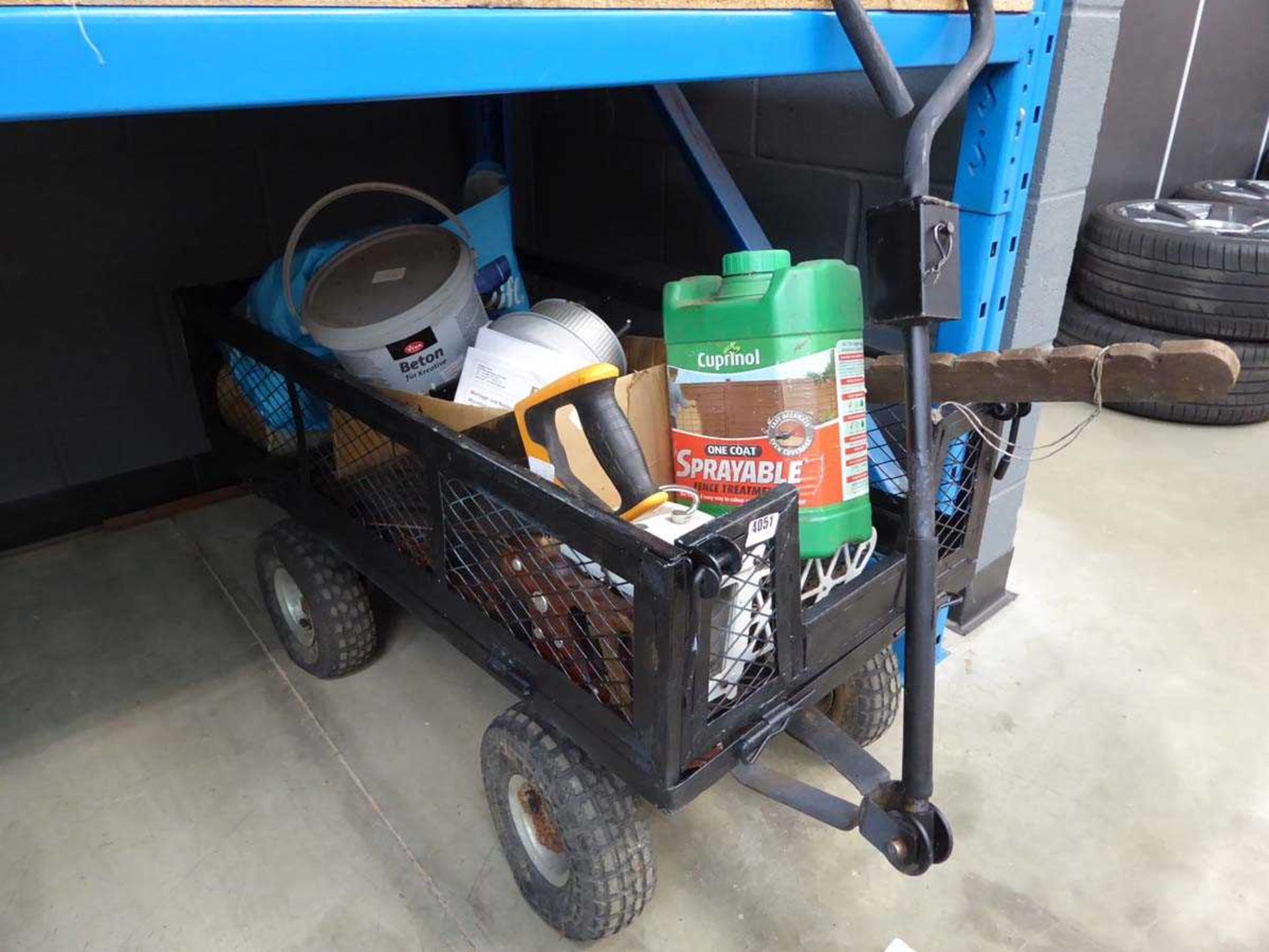 Small 4-wheeled cart containing handsaws, fence treatment, tools etc.