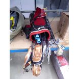Red golf bag with assorted clubs and extra clubs