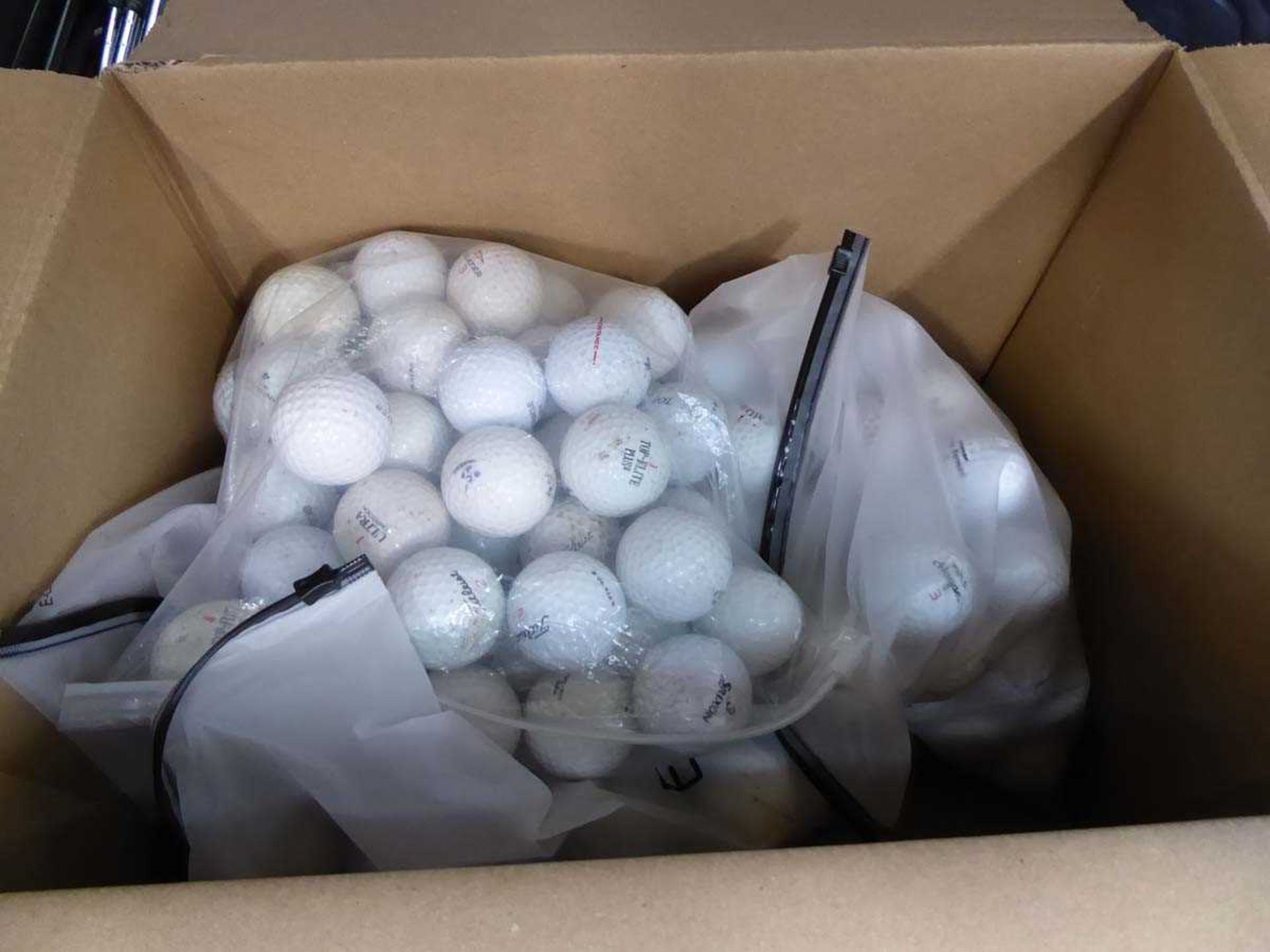 Box of assorted golf balls