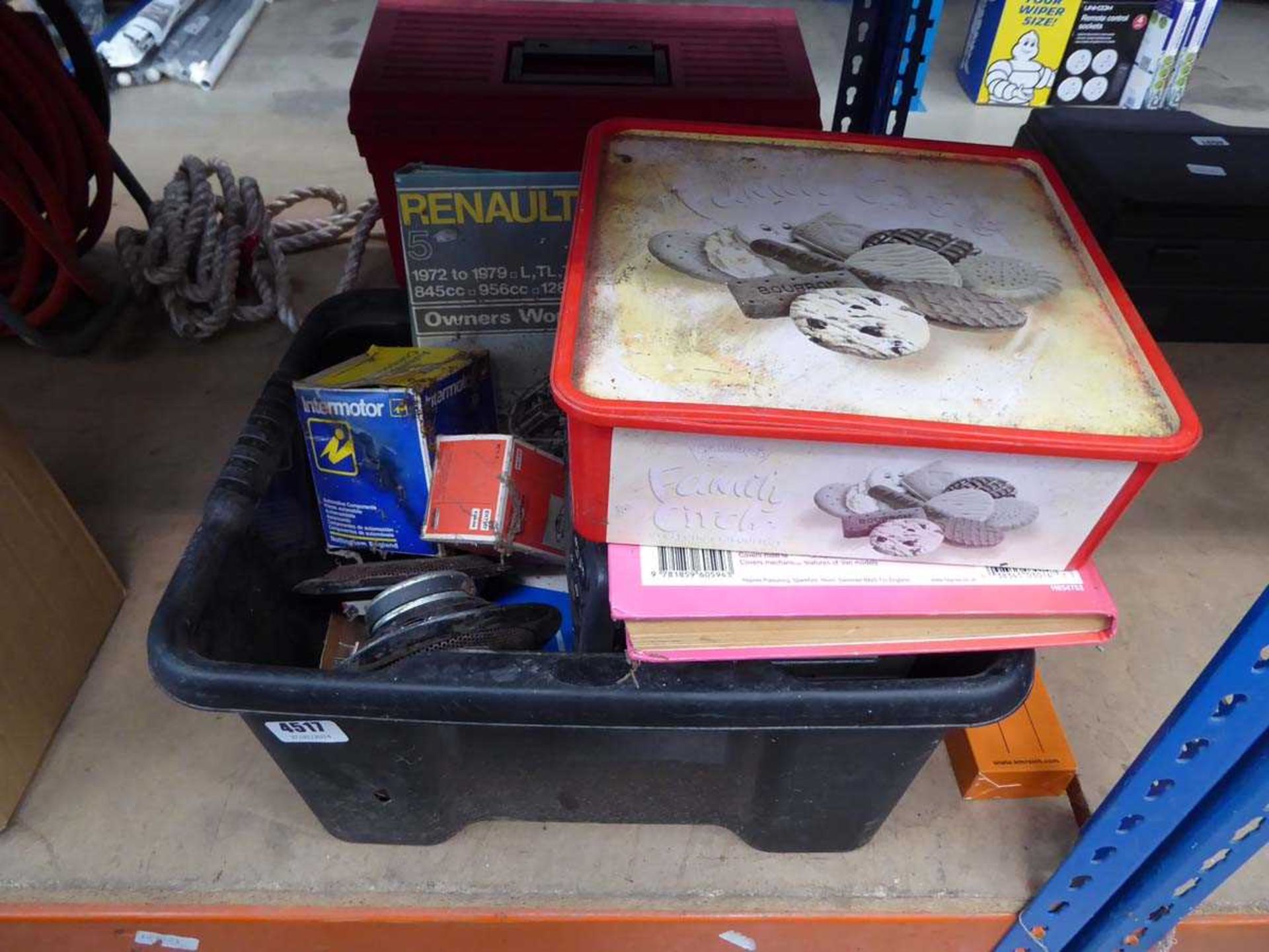 Box containing vintage car parts and manuals