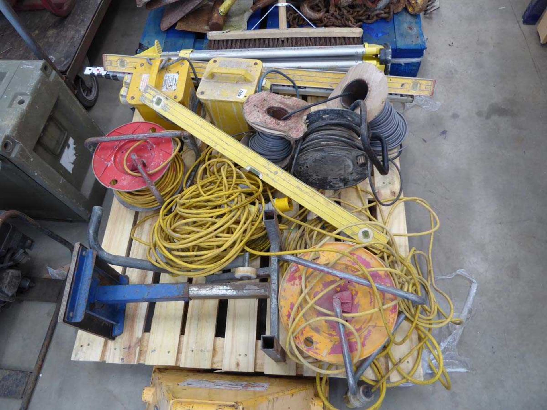 Pallet of assorted tools to include transformers, extension cables, site level stand etc