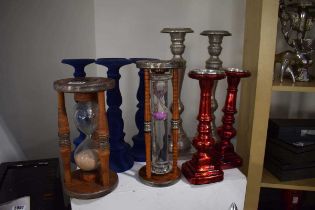 Set of four blue velvet-style candlesticks together with two other pairs of candlesticks and two