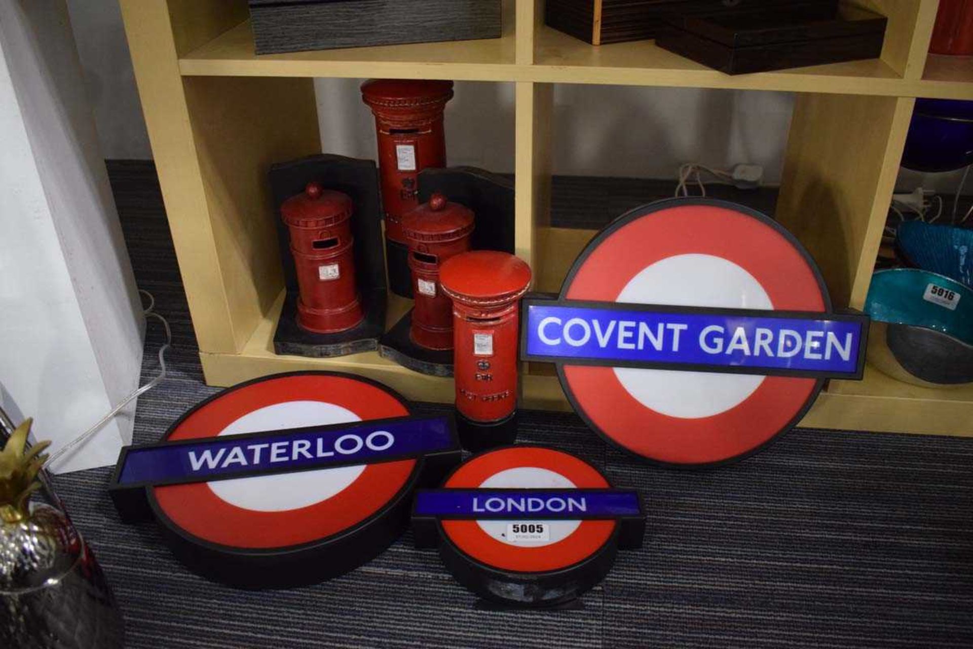 Three reproduction London Underground signs together with post box bookends and ornaments