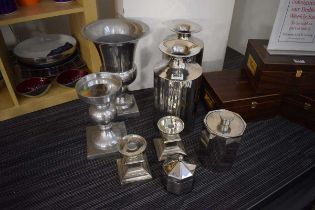Eight silvered/stainless vases, candleholders and containers including one by Nick Munro