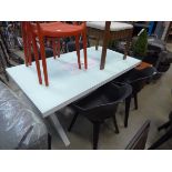 Glass top rectangular table and four plastic tub chairs