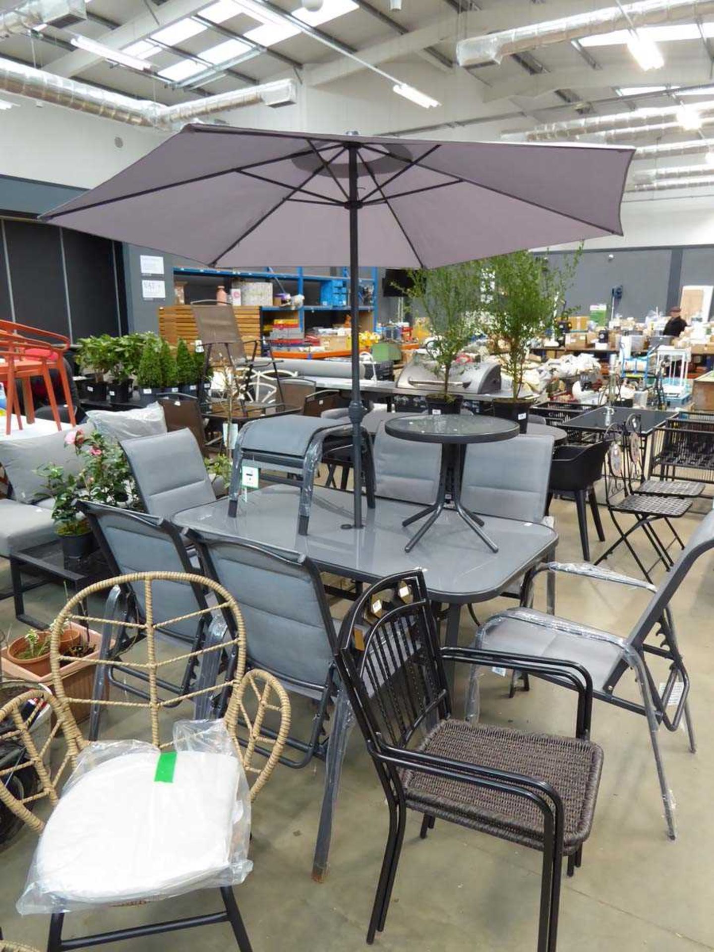 Rectangular garden table with parasol, six chairs, side table and two footstools