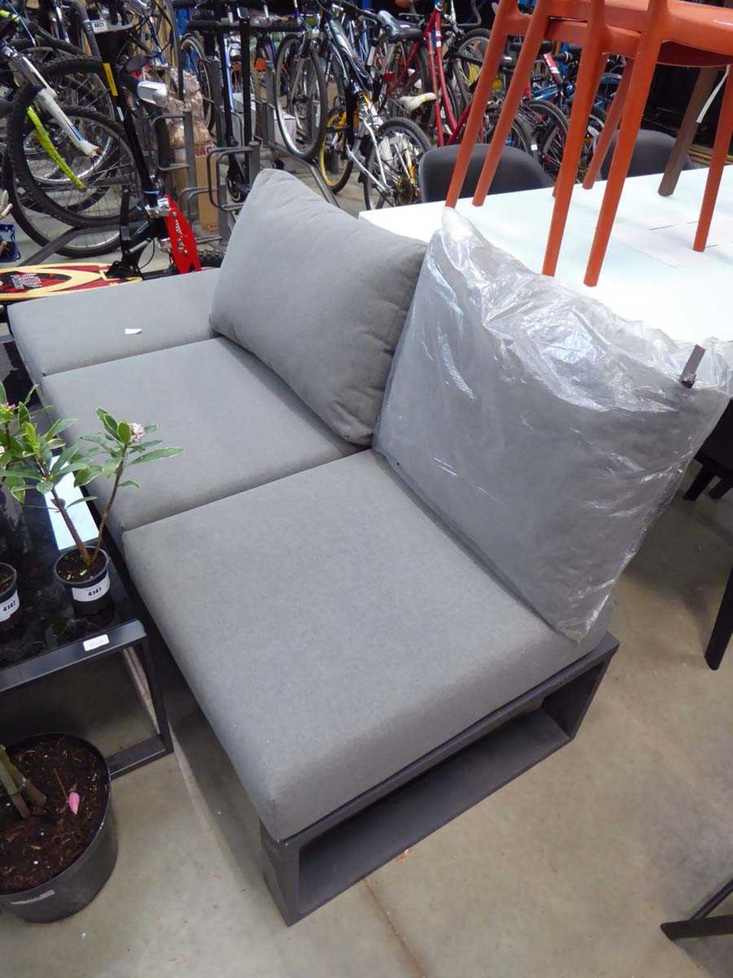 Metal garden seat with grey cushions and glass topped coffee table