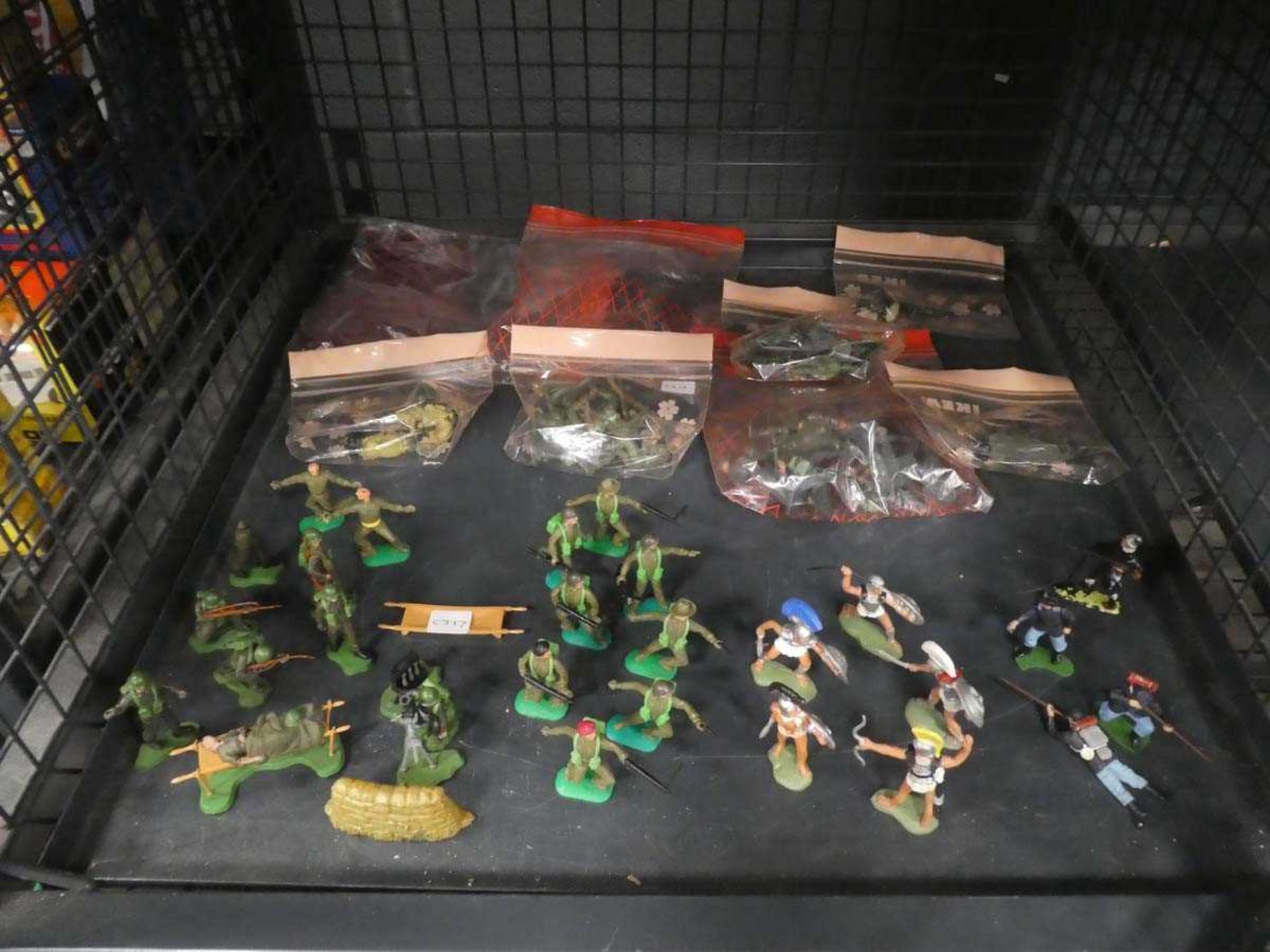 Cage containing plastic toy soldiers