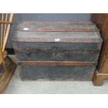 Domed topped canvas and wooden banded travelling trunk