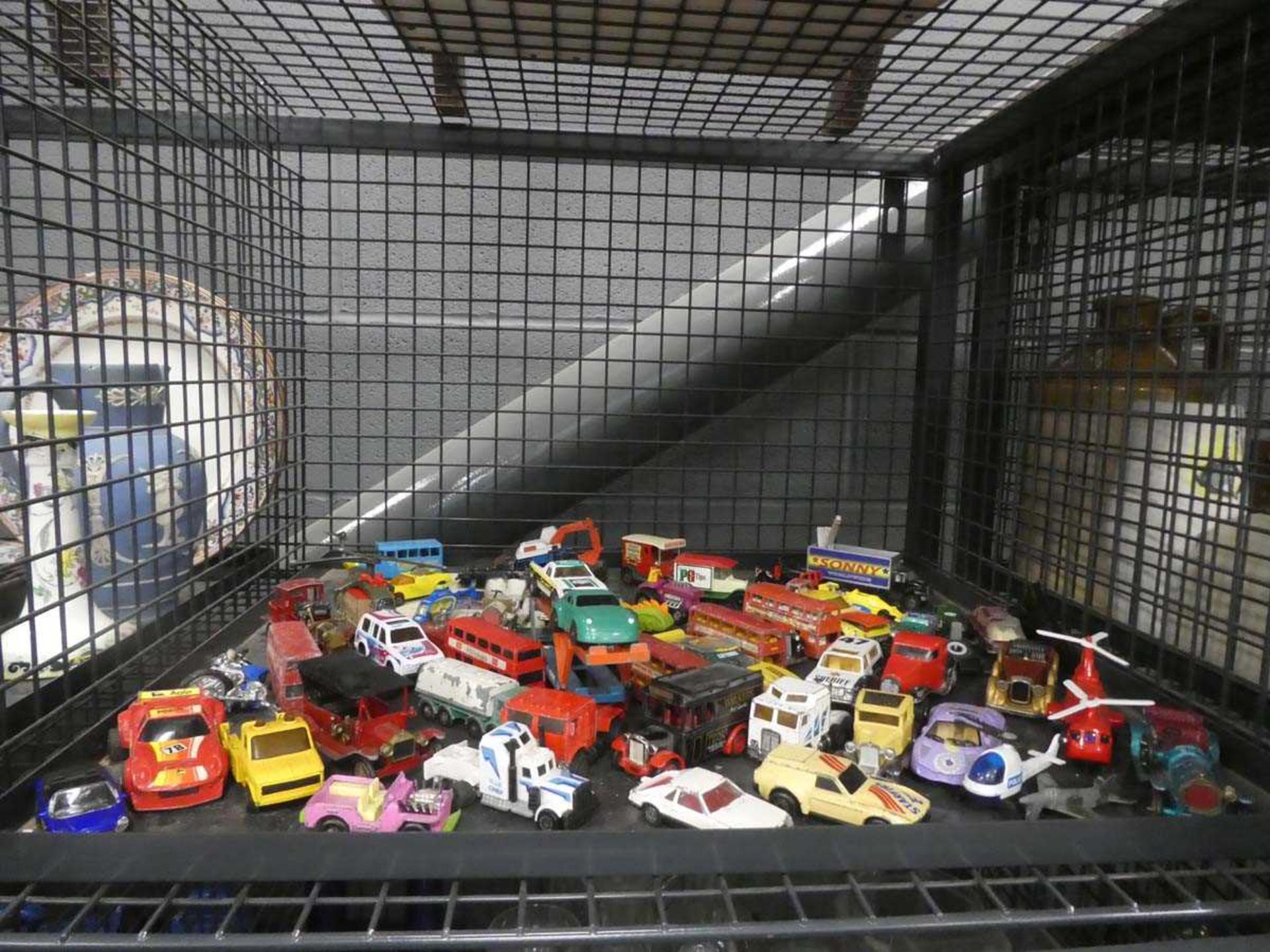 Cage containing play worn diecast vehicles