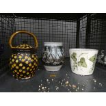 Cage containing a hop patterned bowl plus 2 other studio pots