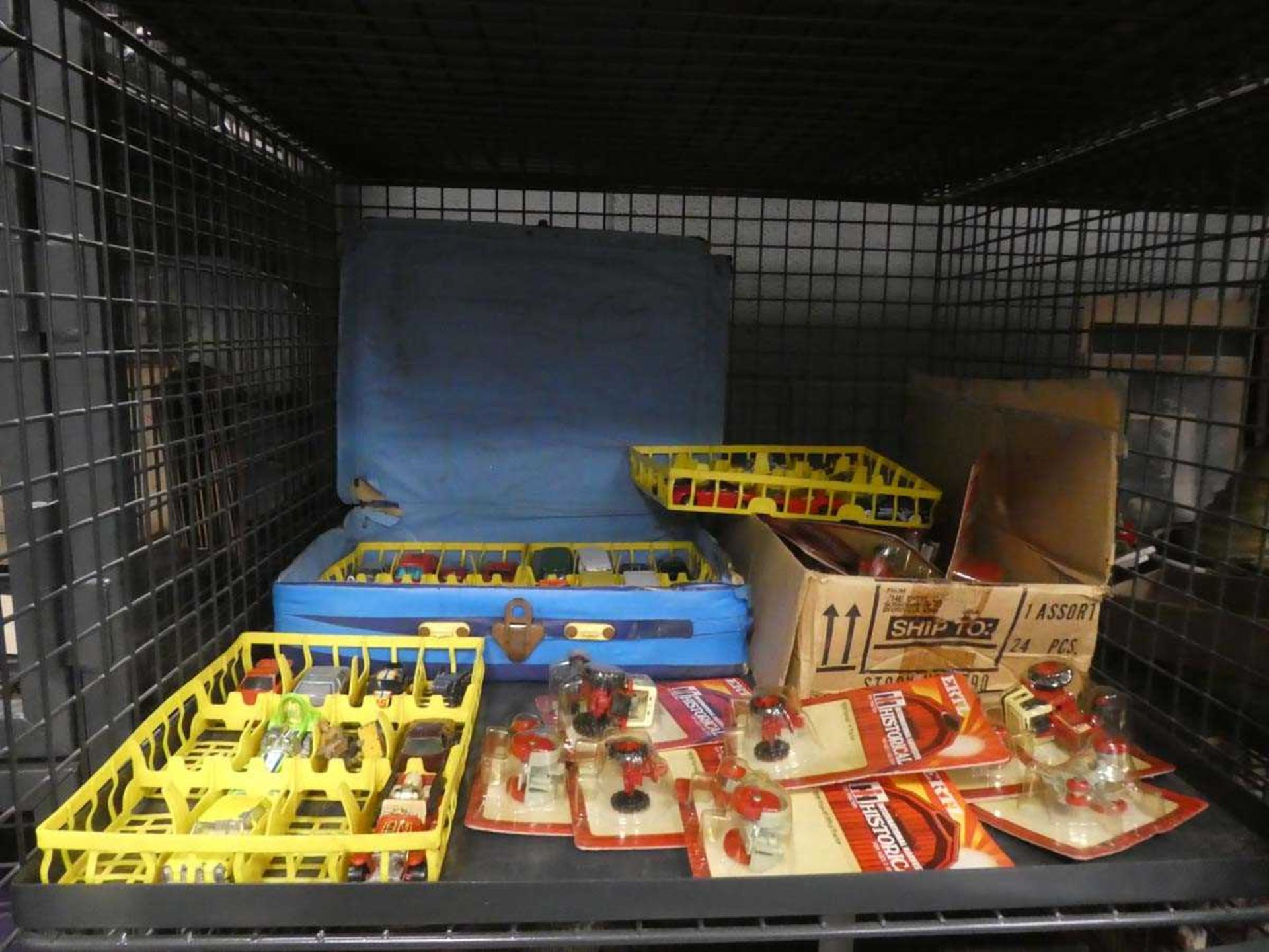 Cage containing boxed and loose diecast vehicles