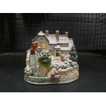 Cage containing a Lilliput lane watermill cottage