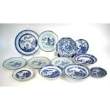 A set of four Chinese blue and white side plates, each decorated with a pine tree landscape by a