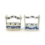 A near pair of Japanese blue and white planters in the form of water carriers, each decorated with