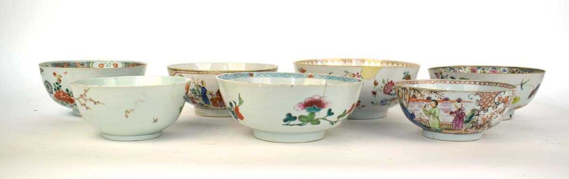 A Chinese bowl externally decorated in coloured enamels with a processional scene and centrally