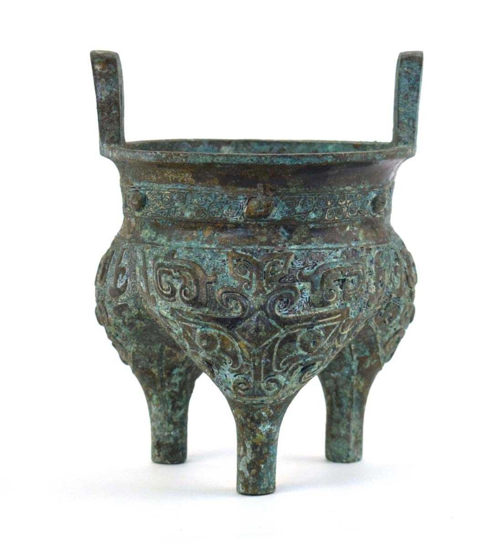 A Chinese green patinated bronze incense burner of archaic form, the triform base decorated with