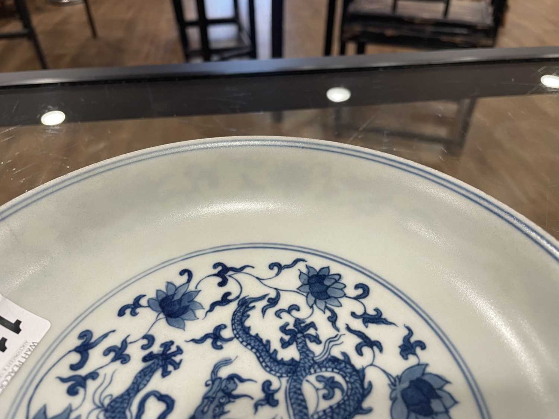 A Chinese blue and white shallow dish, centrally decorated with a dragon and lotus flowers, pseudo - Image 28 of 31