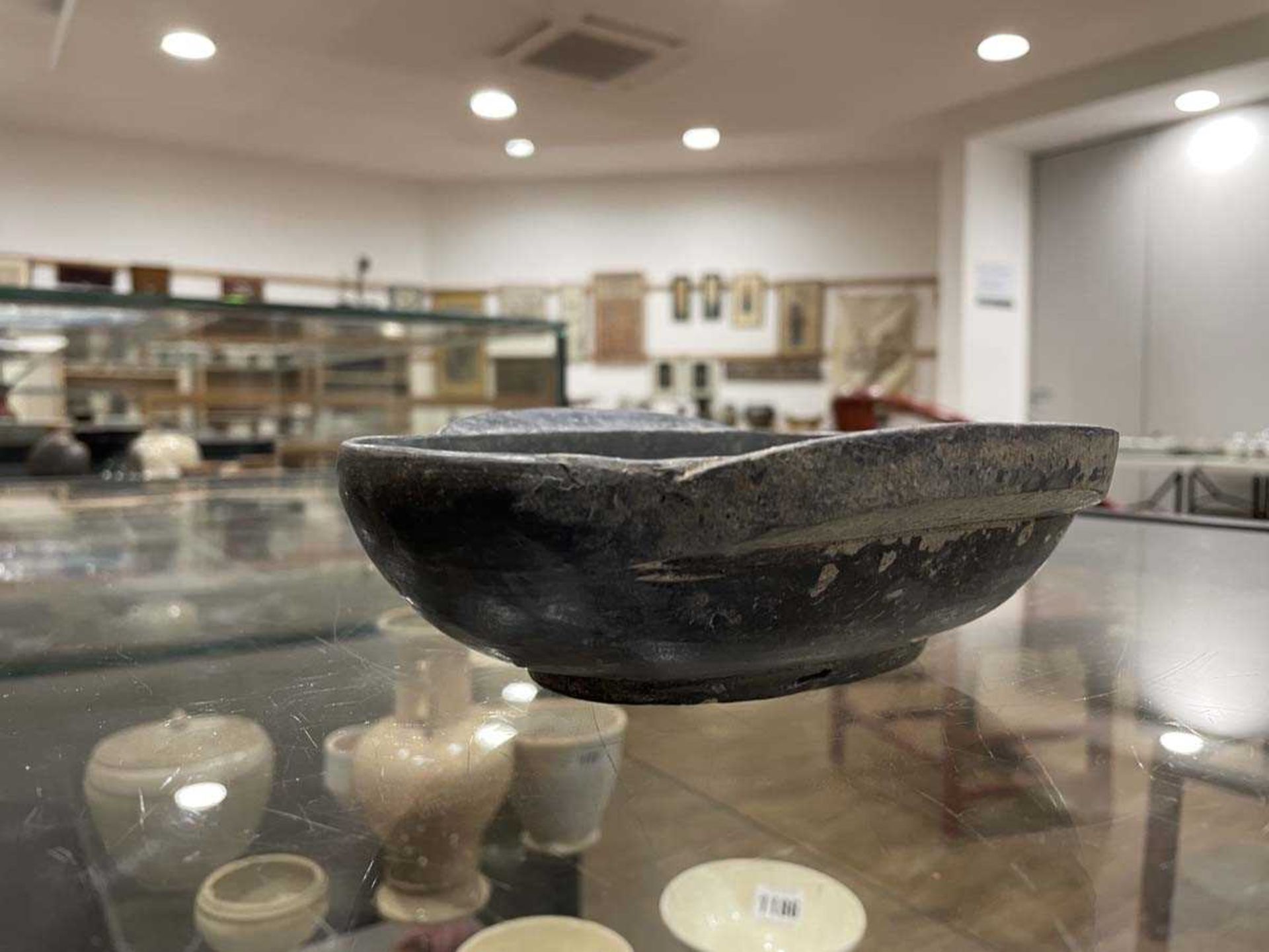 A Chinese archaic pottery ear cup decorated in a black glaze, l. 18 cm, boxed, together with two - Bild 16 aus 19