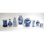 A Chinese blue and white blossom pattern brush pot of cylindrical form on a fixed hardwood base,