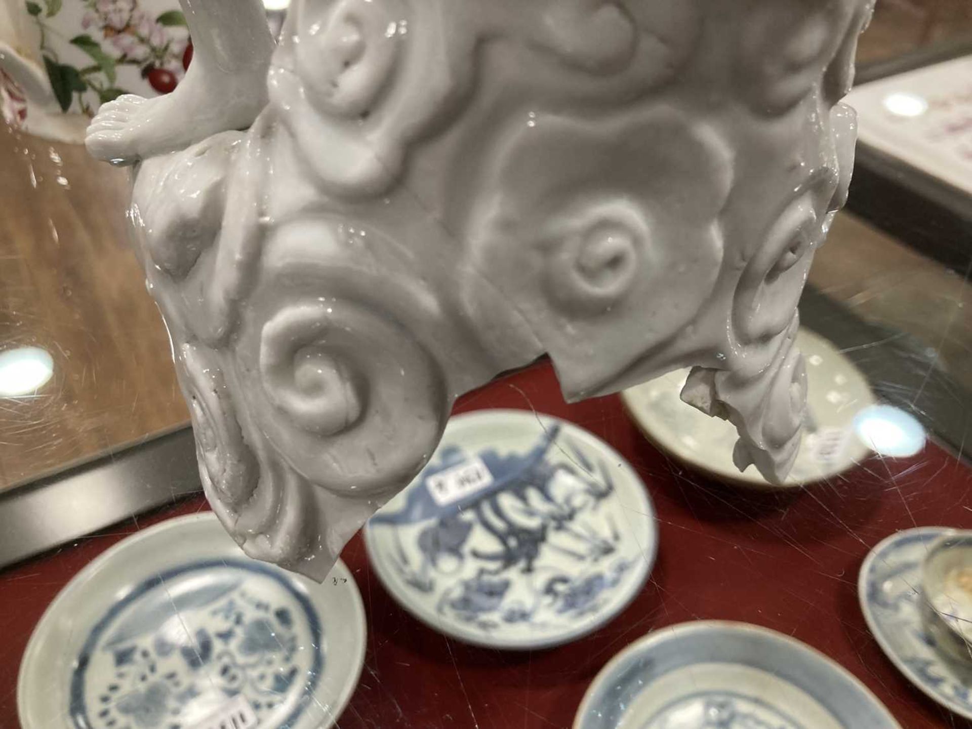 A Chinese blanc de chine figure, possibly Dong Fangshuo, holding a walking stick on a swirl design - Bild 4 aus 22