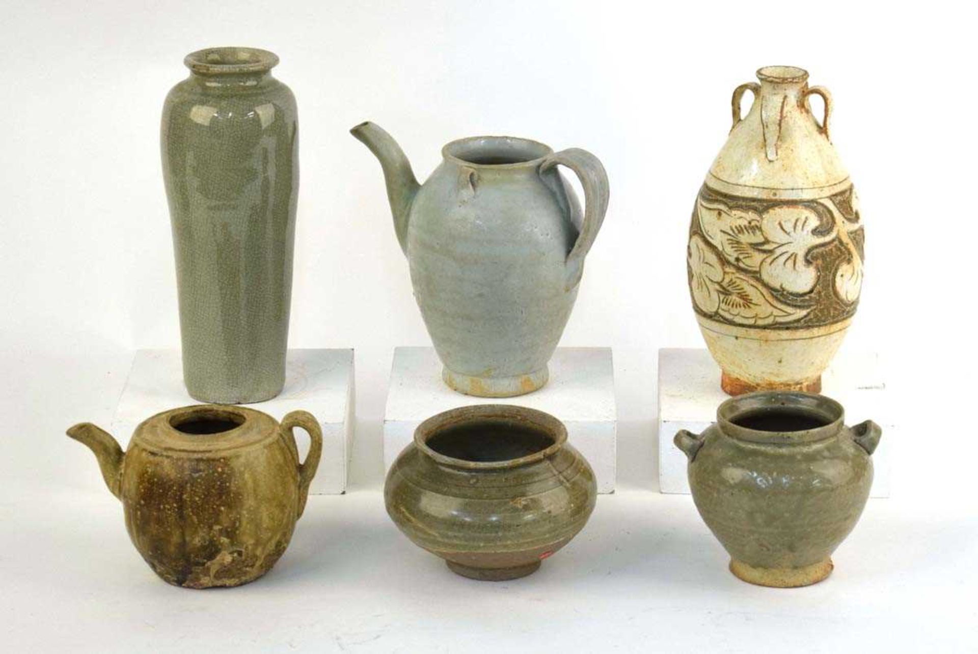 A Chinese celadon teapot of ovoid form, h. 16 cm and five further items of celadon and stoneware (6)