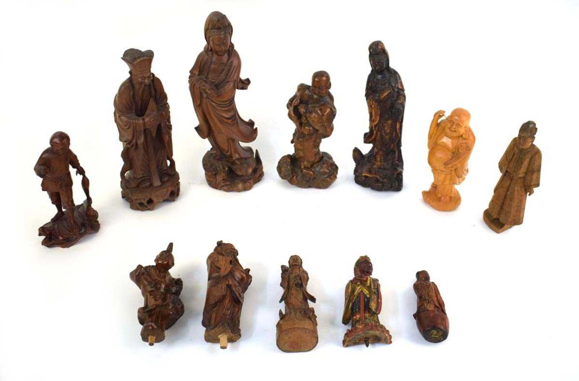 A Chinese carved wood figure modelled as a fisherman and his catch, h. 18 cm, together with ten