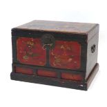A Chinese lacquered pine chest, the lid opening to reveal a vacant interior, over three faux