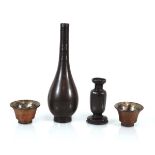 A brown patinated bronze bottle vase of slender form, h. 24.5 cm, a further vase, smaller and a pair