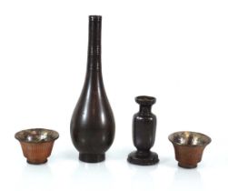 A brown patinated bronze bottle vase of slender form, h. 24.5 cm, a further vase, smaller and a pair
