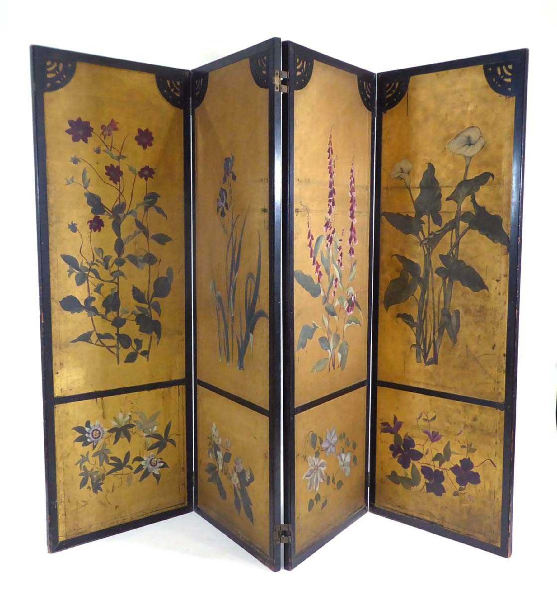 A Japanese four section screen, each panel gilt decorated with floral sprays within a black