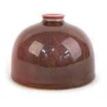 A Chinese sang de boeuf crackle glaze water pot of squat form, Kangxi mark to base, h. 9 cm, d. 12.5