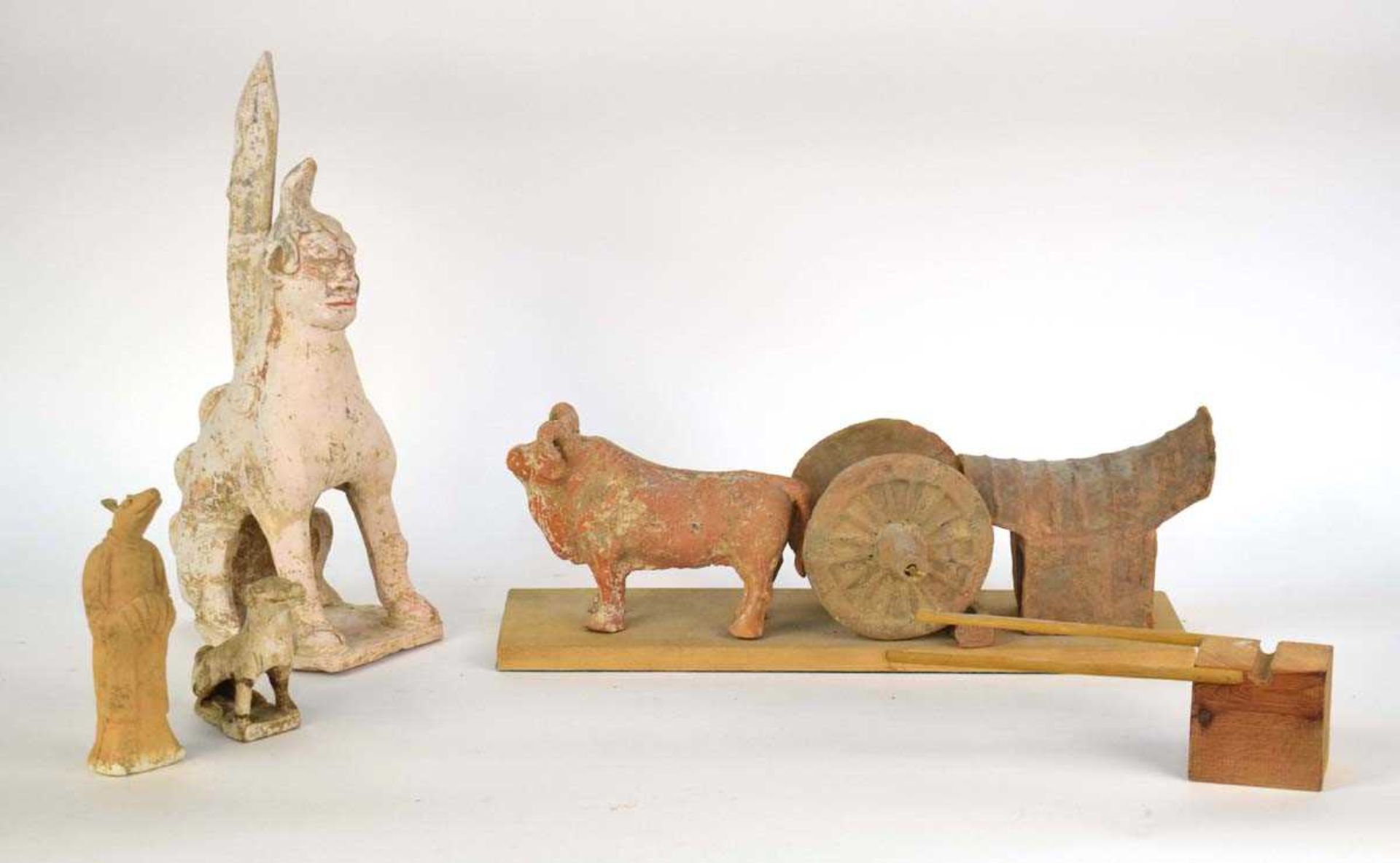 A Chinese pottery tomb figure modelled as an ox and cart, possibly Tang, w. 15.5 cm, together with