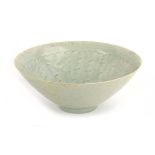 A Chinese celadon bowl of flared circular form, relief decorated with cloud like motifs, d. 20.5 cm,