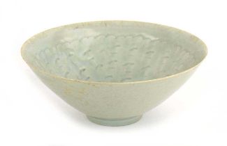 A Chinese celadon bowl of flared circular form, relief decorated with cloud like motifs, d. 20.5 cm,