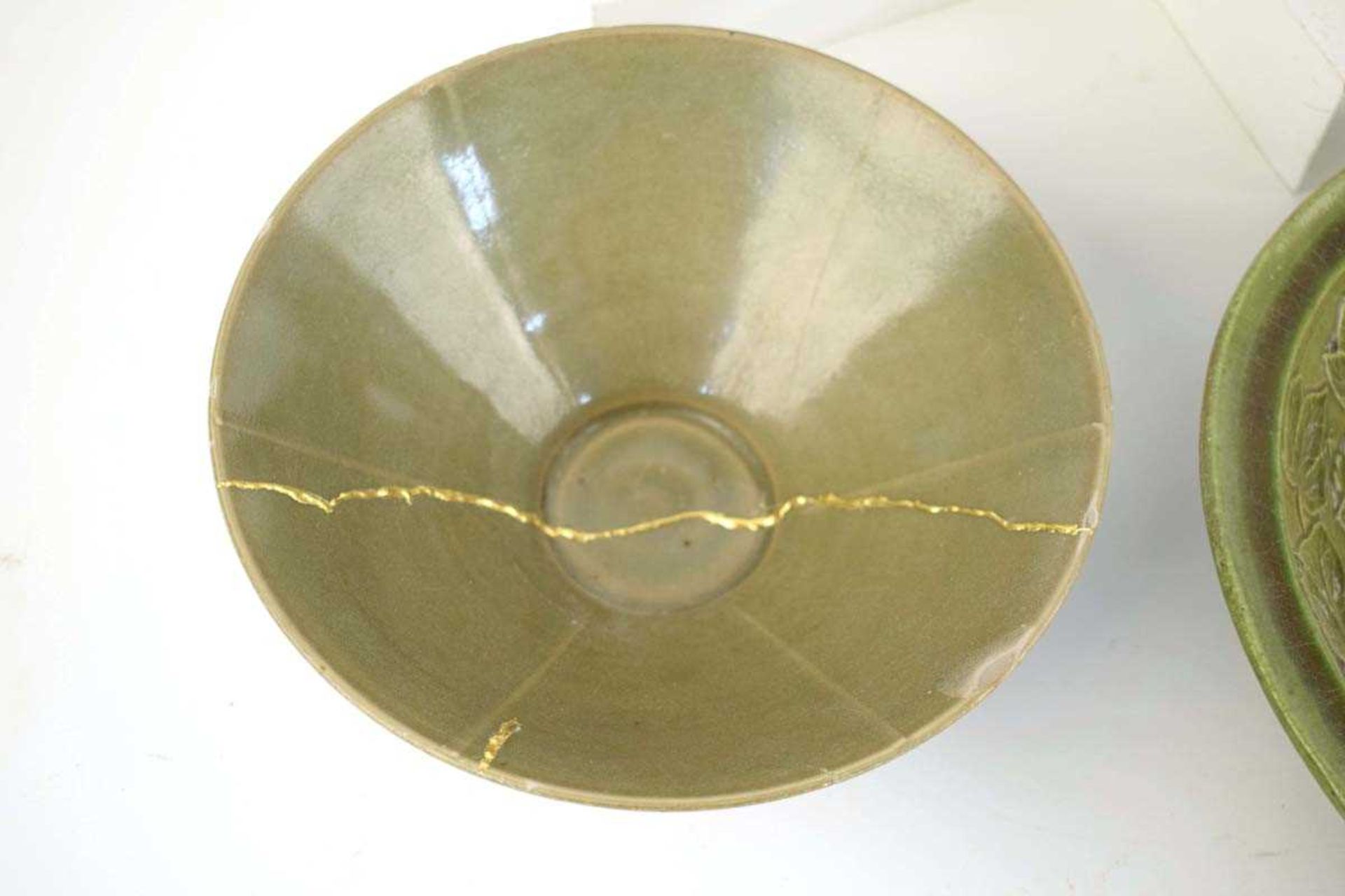 A Chinese celadon bowl of circular form repaired with the Kintsugi technique, d. 19.5 cm, h. 7.5 cm, - Image 3 of 21