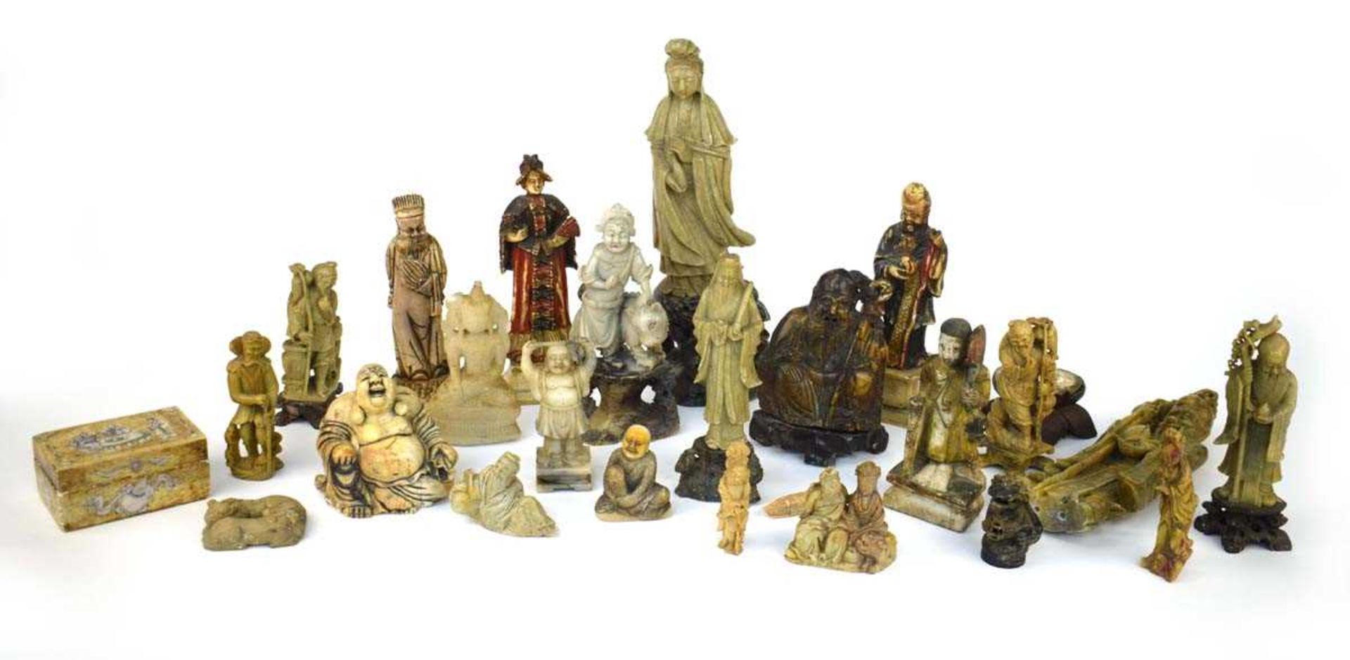 Twenty-five Chinese carved soapstone and other figures including an example of Guanyin, h. 35.5