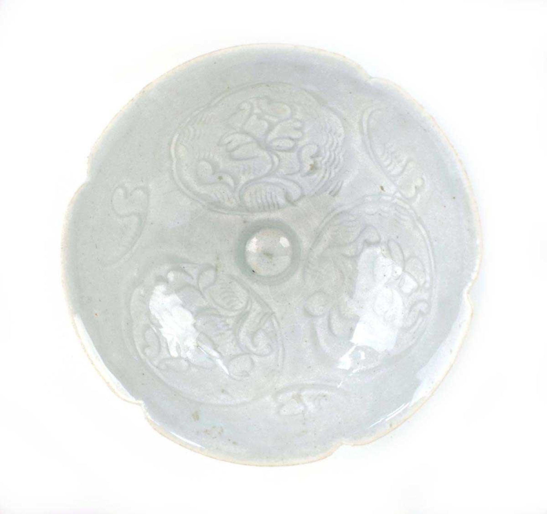 A small Chinese shallow celadon dish of flowerhead form decorated with stylised foliate motifs, d.