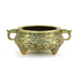 A 19th century Chinese bronze two handled censer relief decorated with stylised dragons on three