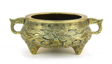 A 19th century Chinese bronze two handled censer relief decorated with stylised dragons on three