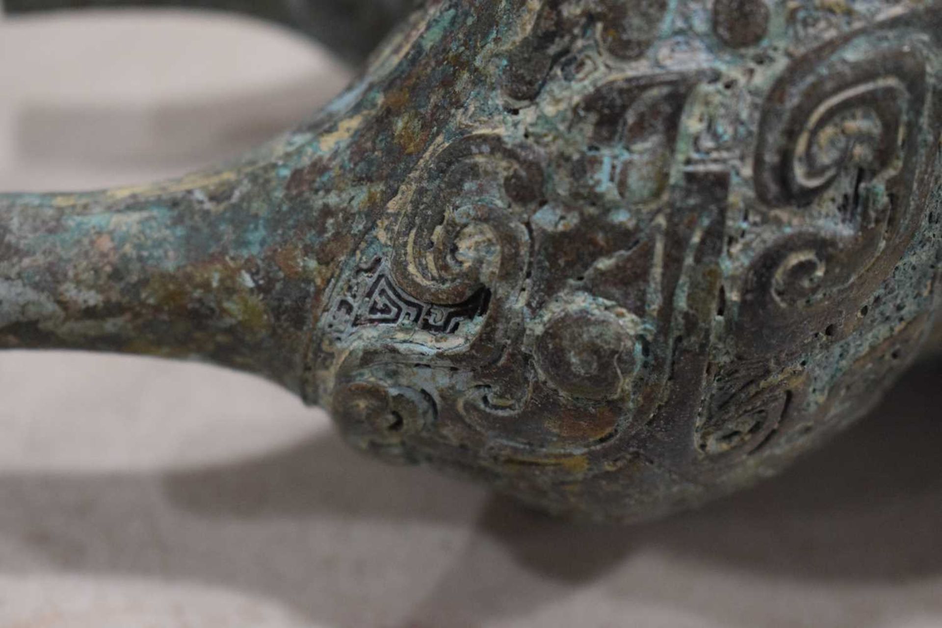 A Chinese green patinated bronze incense burner of archaic form, the triform base decorated with - Image 27 of 29